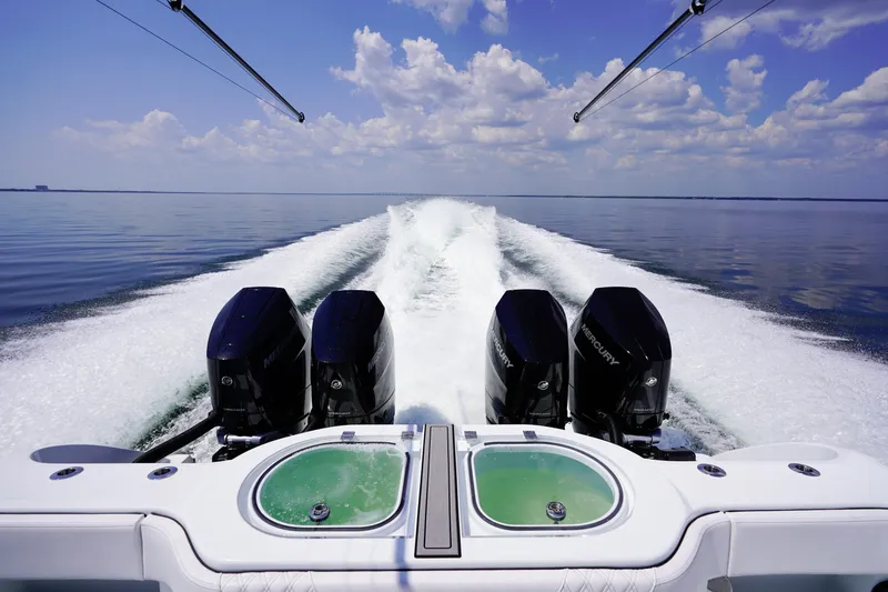 Slide: The Image of 2026 Invincible 40 Catamaran with powerful Mercury engines cruising on calm waters. - 32