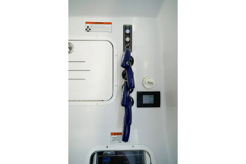 Slide: The Image of Interior view of 2026 Invincible 40 Catamaran control panel with safety equipment. - 37