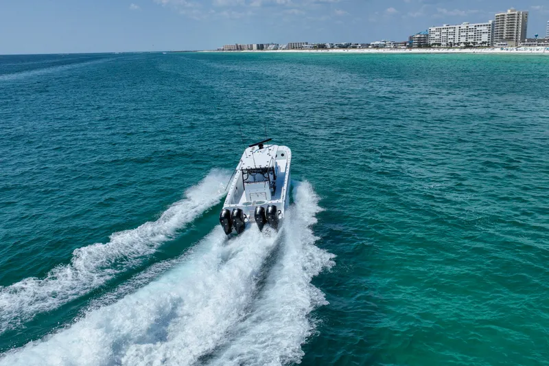 Slide: The Image of 2026 Invincible 40 Catamaran cruising on turquoise ocean near coastline. - 46