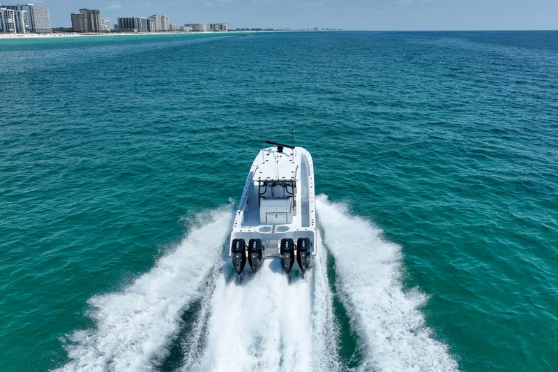 Slide: The Image of 2026 Invincible 40 Catamaran cruising on open ocean near city skyline. - 49