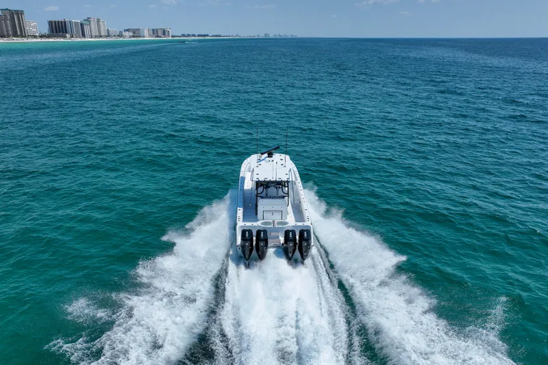 Slide: The Image of 2026 Invincible 40 Catamaran cruising on open ocean near city skyline. - 50