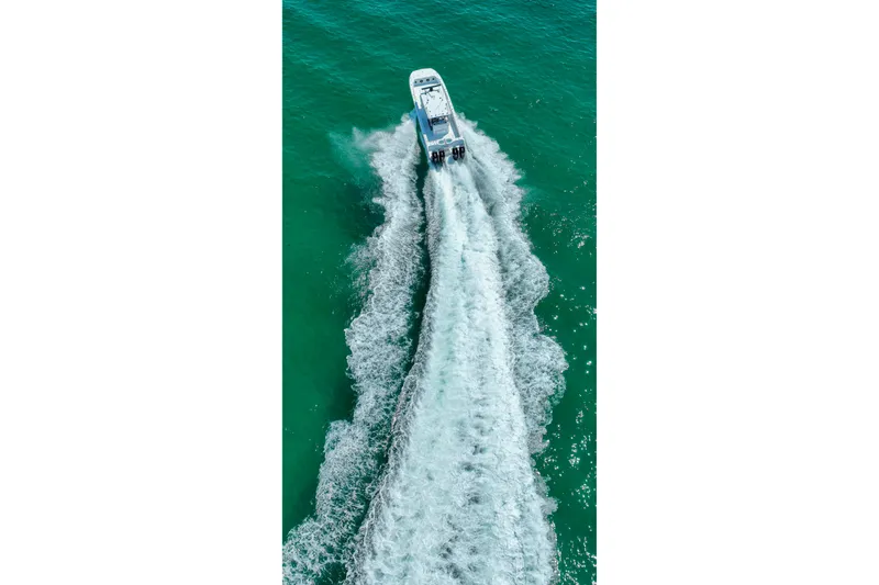 Slide: The Image of Aerial view of 2026 Invincible 40 Catamaran cruising on turquoise water. - 56