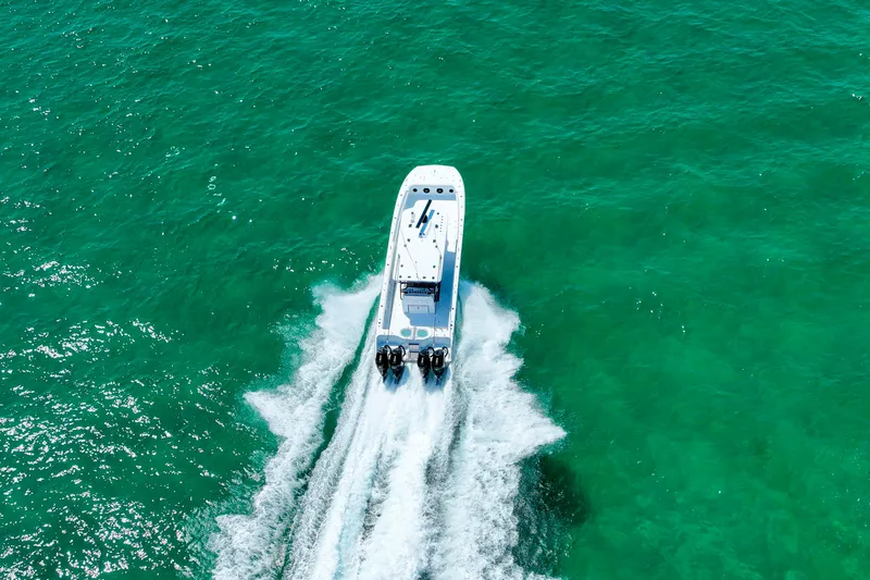 Slide: The Image of Aerial view of 2026 Invincible 40 Catamaran cruising on turquoise water. - 57