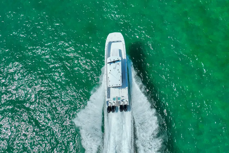 Slide: The Image of Aerial view of 2026 Invincible 40 Catamaran cruising on vibrant turquoise water. - 58