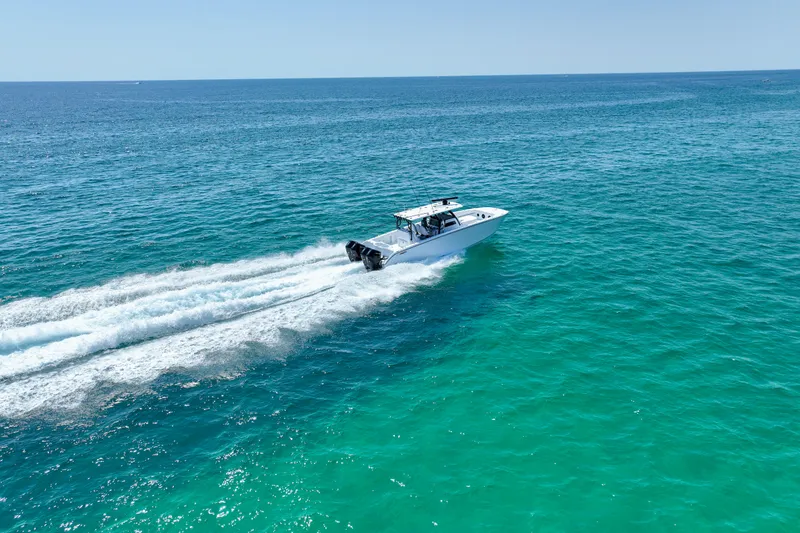 Slide: The Image of 2026 Invincible 40 Catamaran cruising on clear blue ocean waters. - 59