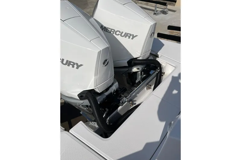 Slide: The Image of 2023 Bertram 28 CC boat with dual Mercury outboard engines. - 16