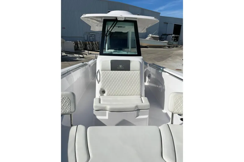 Slide: The Image of 2023 Bertram 28 CC boat interior with white seating and modern design. - 9