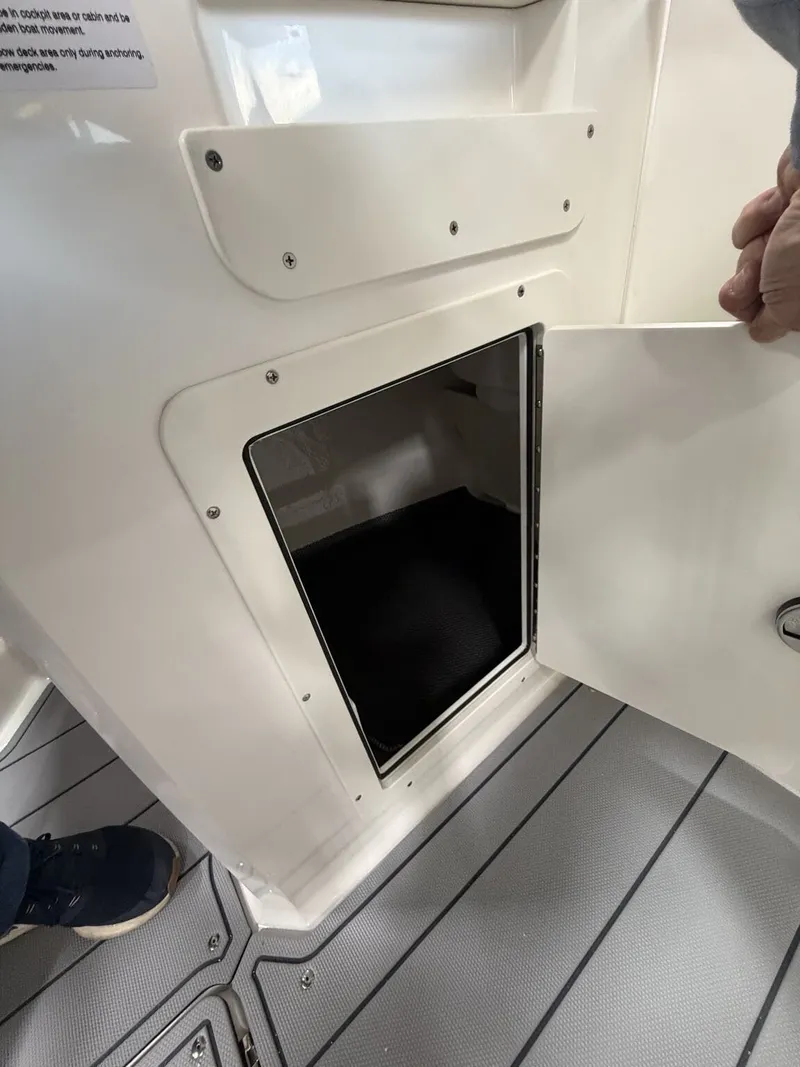 Slide: The Image of Open storage compartment on a 2026 Chaparral SSi 21 boat. - 17