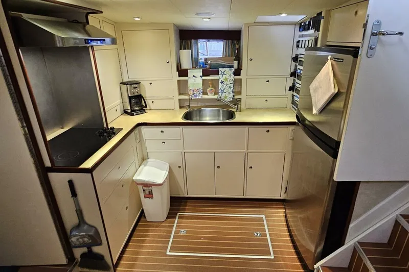 Slide: The Image of 1969 Derecktor 68 Hunt Motor Yacht kitchen with modern appliances and wooden flooring. - 13