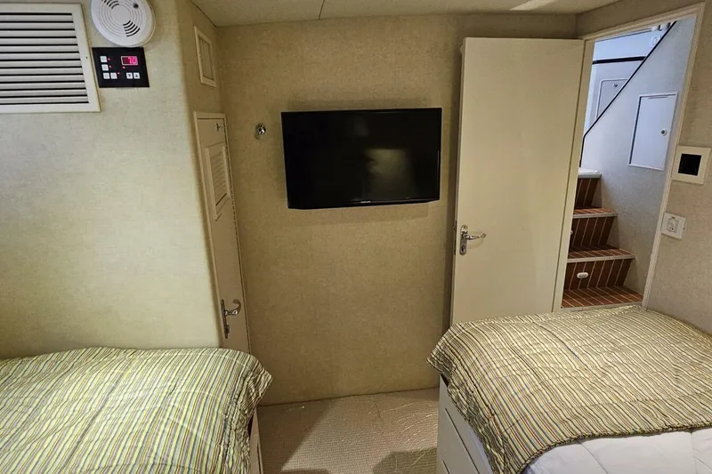 Slide: The Image of Interior of 1969 Derecktor 68 Hunt Motor Yacht with twin beds and wall-mounted TV. - 18