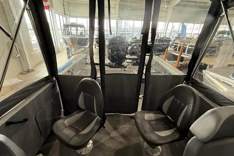 Slide: The Image of 2024 Hewescraft 221 Evolution boat interior with seating and clear canopy. - 11