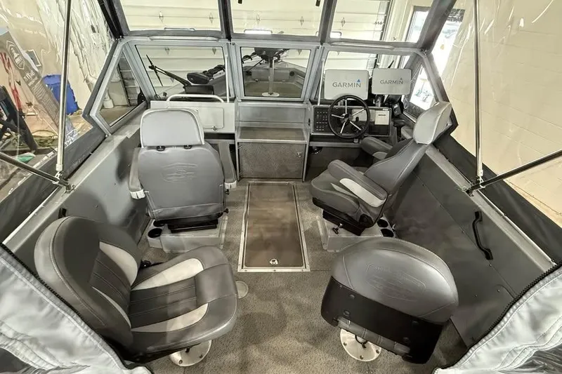 Slide: The Image of 2024 Hewescraft 221 Evolution boat interior with seating and Garmin navigation system. - 12