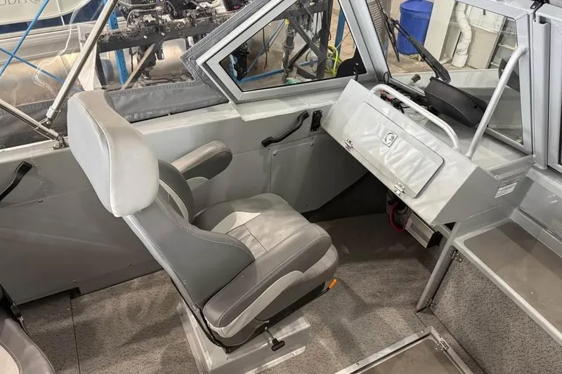 Slide: The Image of 2024 Hewescraft 221 Evolution boat interior with gray seating and control panel. - 13