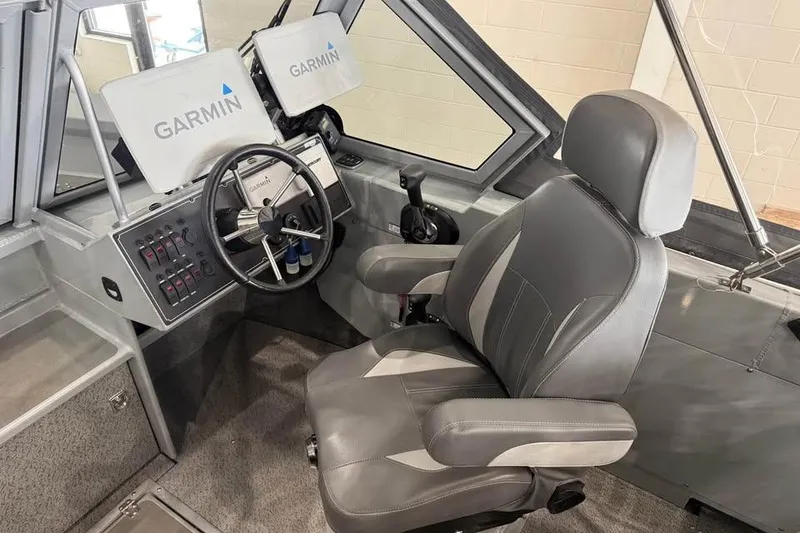 Slide: The Image of 2024 Hewescraft 221 Evolution boat interior with Garmin navigation system and captain's chair. - 15