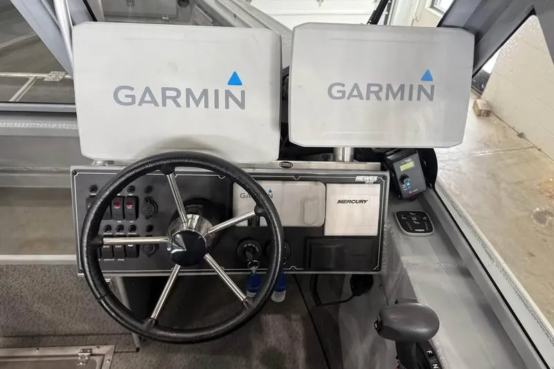 Slide: The Image of 2024 Hewescraft 221 Evolution boat dashboard with Garmin navigation displays. - 17