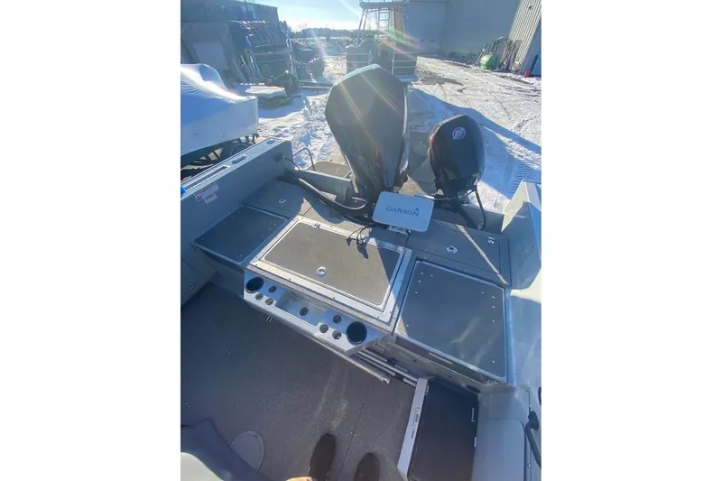 Slide: The Image of 2024 Hewescraft 221 Evolution boat interior with Garmin equipment, parked on snowy ground. - 7