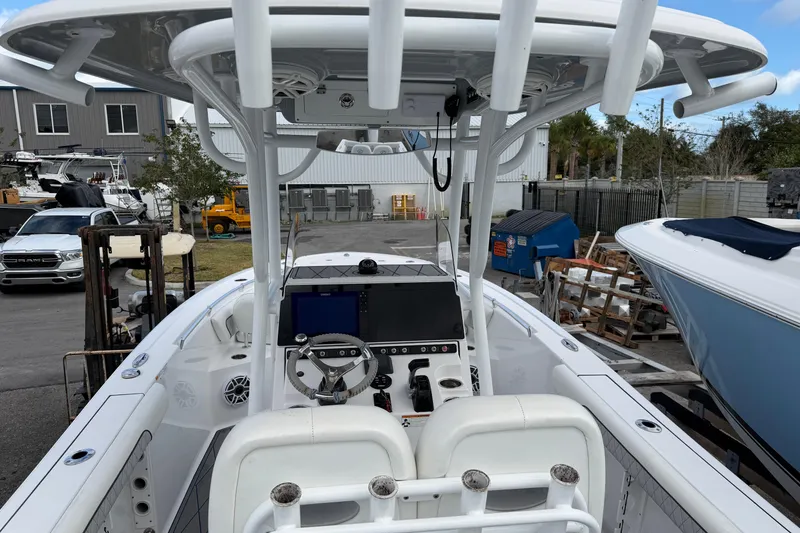 Slide: The Image of 2018 Sportsman Heritage 241 Center Console boat interior with steering and navigation equipment. - 10