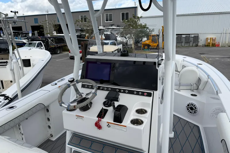 Slide: The Image of 2018 Sportsman Heritage 241 Center Console boat interior with steering wheel and control panel. - 11