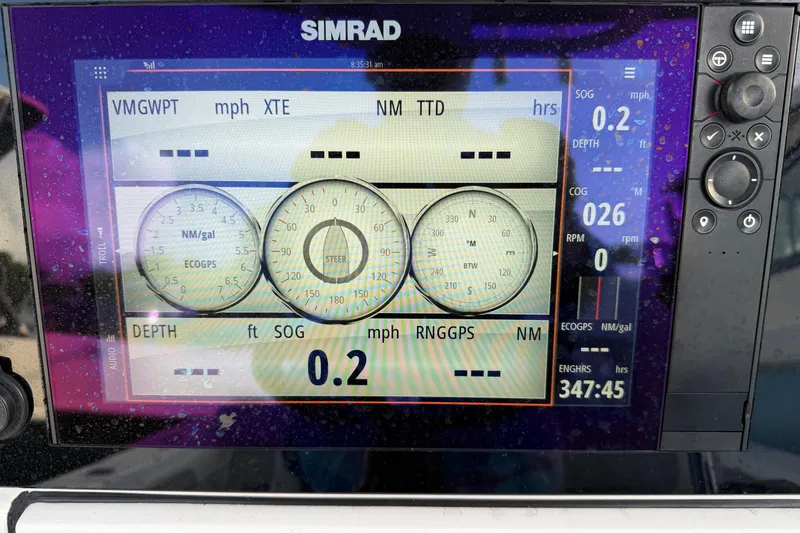 Slide: The Image of Simrad marine display on 2018 Sportsman Heritage 241 Center Console showing navigation data. - 13