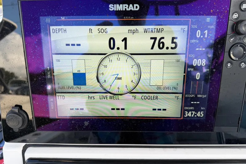 Slide: The Image of Simrad display on 2018 Sportsman Heritage 241 Center Console showing navigation and engine data. - 14