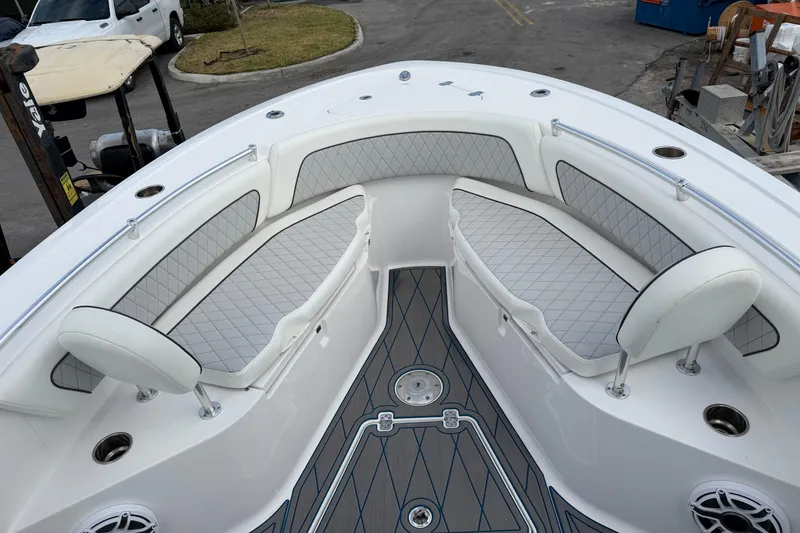 Slide: The Image of 2018 Sportsman Heritage 241 Center Console boat with cushioned seating and sleek design. - 17