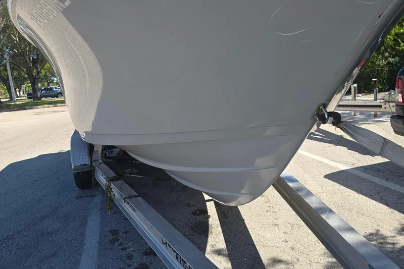 Slide: The Image of 2018 Sportsman Heritage 241 Center Console boat on trailer in parking lot. - 18