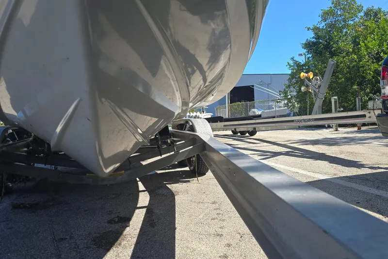 Slide: The Image of 2018 Sportsman Heritage 241 Center Console boat on trailer, parked outdoors. - 22