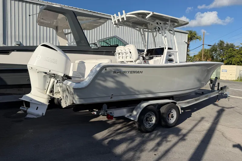 Slide: The Image of 2018 Sportsman Heritage 241 Center Console boat on trailer, parked outdoors. - 3