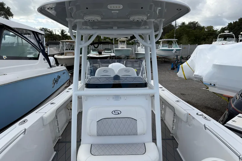 Slide: The Image of 2018 Sportsman Heritage 241 Center Console boat, docked among other vessels. - 9