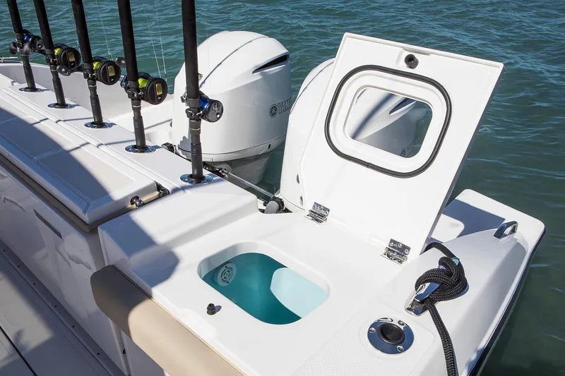 Slide: The Image of Manufacturer Provided Image: 2022 Pursuit S 328 Sport boat with open storage compartment and fishing rod holders. - 30