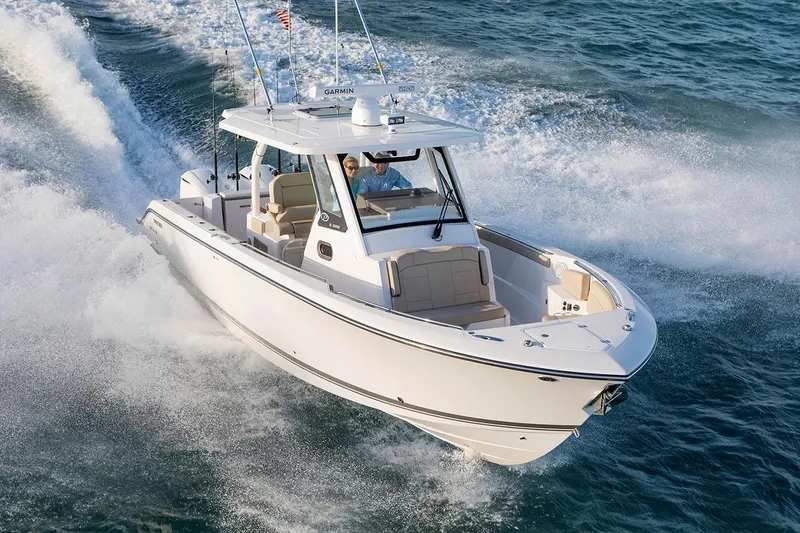 Slide: The Image of 2022 Pursuit S 328 Sport boat dashboard with steering wheel and navigation controls. - 4