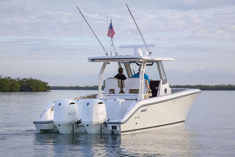 Slide: The Image of 2022 Pursuit S 328 Sport boat with spacious seating in a marina setting. - 6