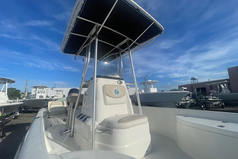 Slide: The Image of 2016 NauticStar 2110 Sport boat with T-top under clear blue sky. - 10