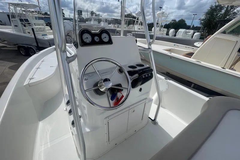 Slide: The Image of 2016 NauticStar 2110 Sport boat console with steering wheel and gauges. - 11
