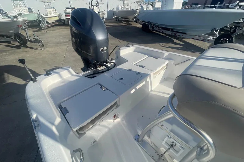 Slide: The Image of 2016 NauticStar 2110 Sport boat with Yamaha 150 engine, docked outdoors. - 5