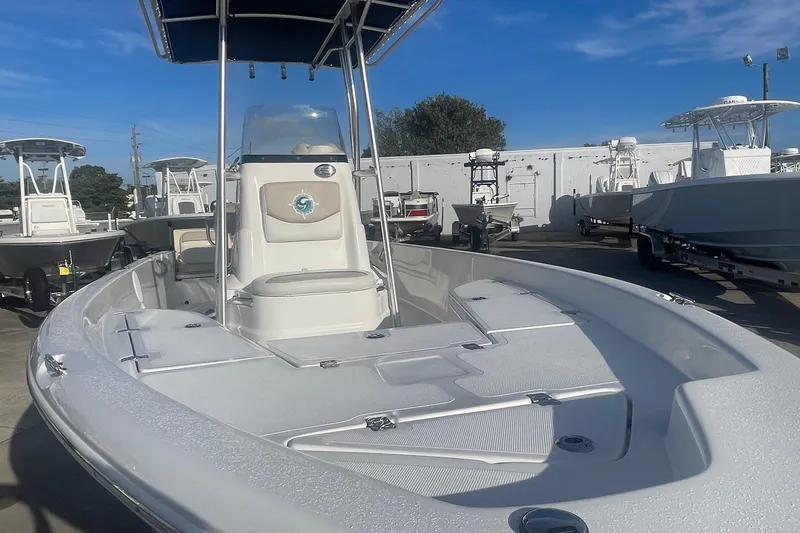 Slide: The Image of 2016 NauticStar 2110 Sport boat with T-top, displayed in a marina under clear blue skies. - 9