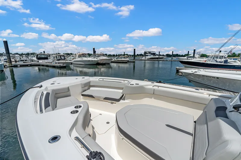 Slide: The Image of The image shows the bow of a Boston Whaler 330 Outrage docked in a marina. - 27