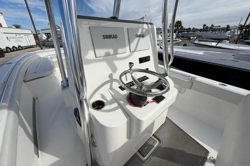 Slide: The Image of 2023 Contender 24 Sport boat console with steering wheel and Simrad electronics. - 12