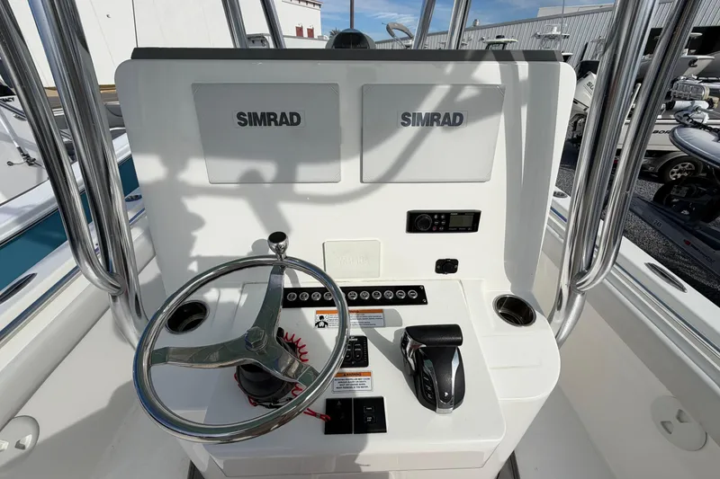 Slide: The Image of 2023 Contender 24 Sport boat console with Simrad electronics and steering wheel. - 14