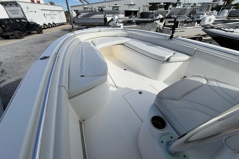 Slide: The Image of 2023 Contender 24 Sport boat interior with cushioned seating and sleek design. - 18