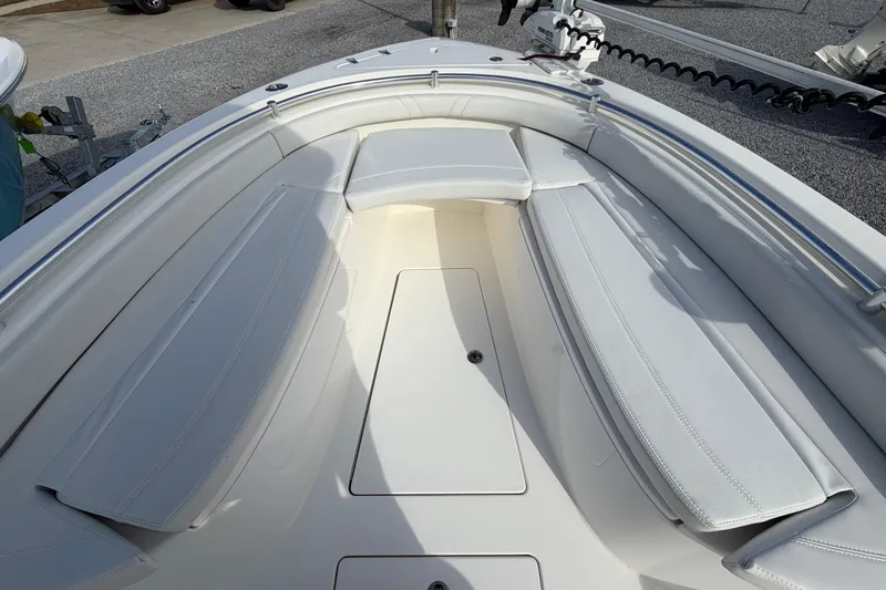Slide: The Image of 2023 Contender 24 Sport boat interior with cushioned seating and storage compartments. - 20