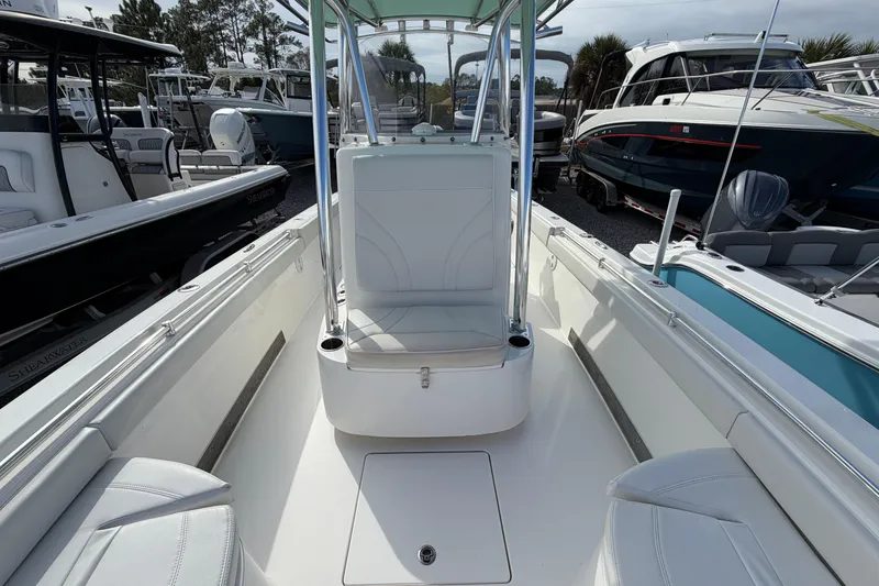 Slide: The Image of 2023 Contender 24 Sport boat interior with seating and console, surrounded by other boats. - 22