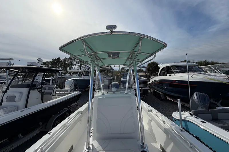 Slide: The Image of 2023 Contender 24 Sport boat in marina, surrounded by various other boats. - 23