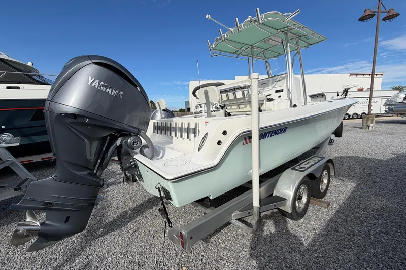 Slide: The Image of 2023 Contender 24 Sport boat with Yamaha outboard engine on trailer, parked outdoors. - 3