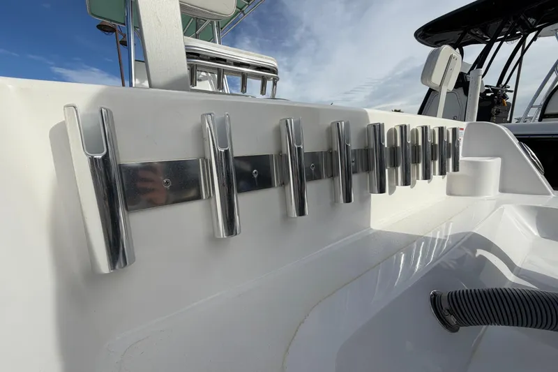 Slide: The Image of 2023 Contender 24 Sport boat with multiple rod holders on deck. - 6