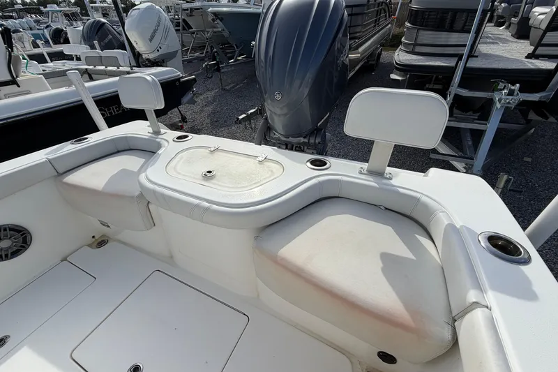 Slide: The Image of 2023 Contender 24 Sport boat interior with seating and engine view. - 7