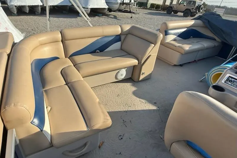 Slide: The Image of 2009 Sweetwater Tuscany Series 2086-23 boat interior with beige and blue seating. - 11