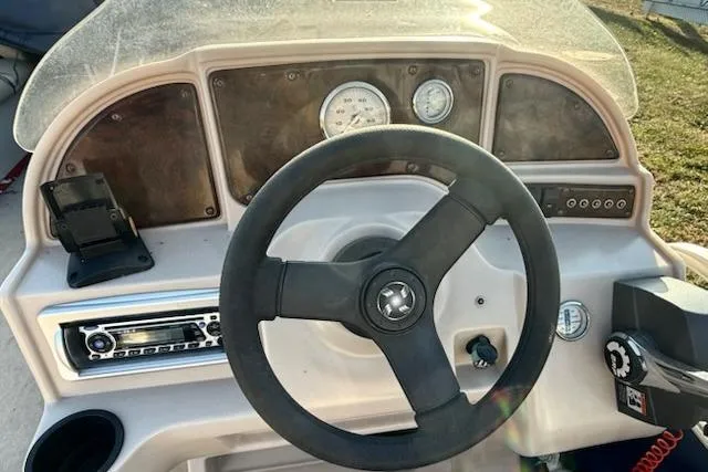 Slide: The Image of Steering console of 2009 Sweetwater Tuscany Series 2086-23 boat with gauges and controls. - 16