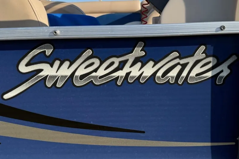 Slide: The Image of Sweetwater Tuscany Series 2086-23 boat logo, 2009 model, on blue background. - 4
