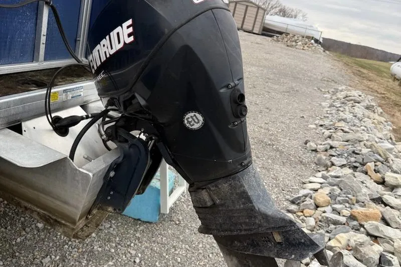 Slide: The Image of Outboard motor on Sweetwater Tuscany Series 2086-23 boat, 2009 model, parked on gravel. - 7